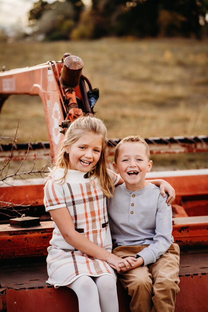 Denver family photographers capture children sitting on tractor