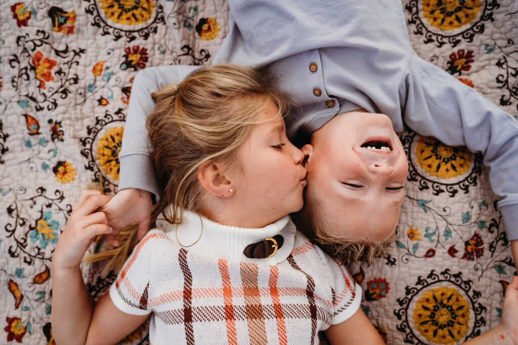 Denver family photographers capture sister kissing brothers cheek
