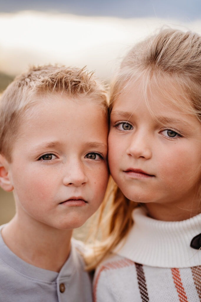 Denver family photographers capture children touching cheeks