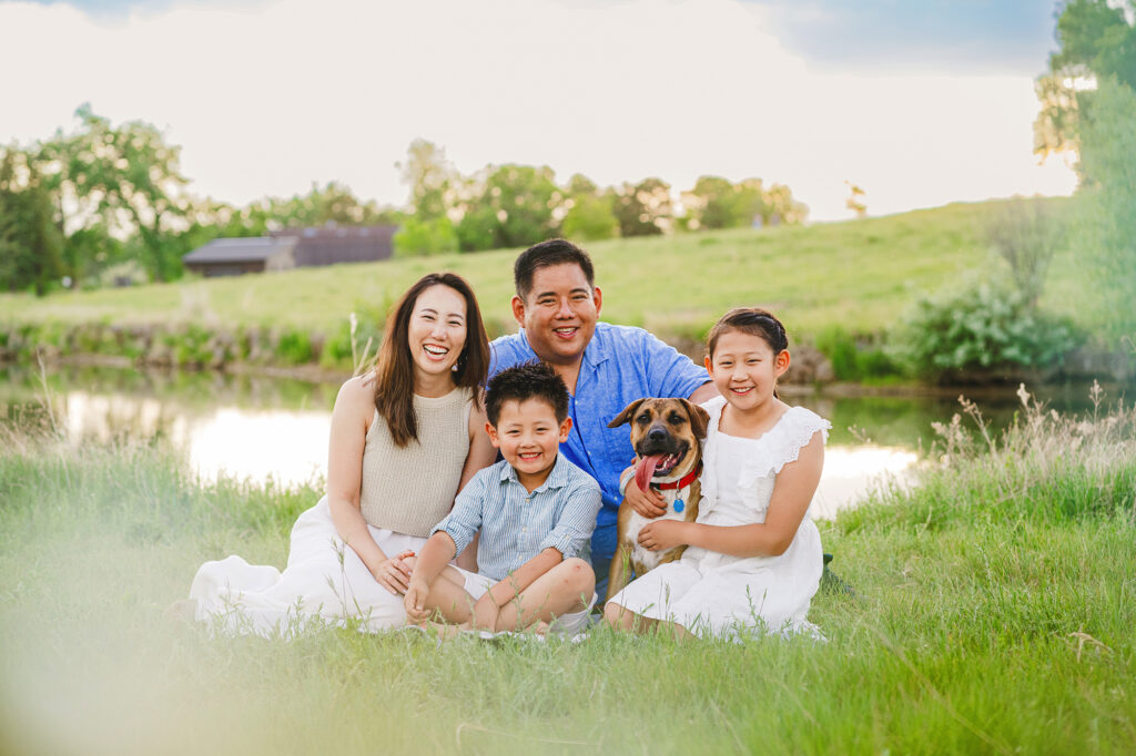 Denver family photographer captures family sitting in grass together