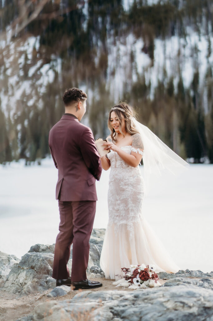 Colorado elopement photographer captures bride reading vows to groom 