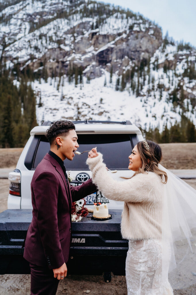 Colorado elopement photographer captures bride feeding groom wedding cake