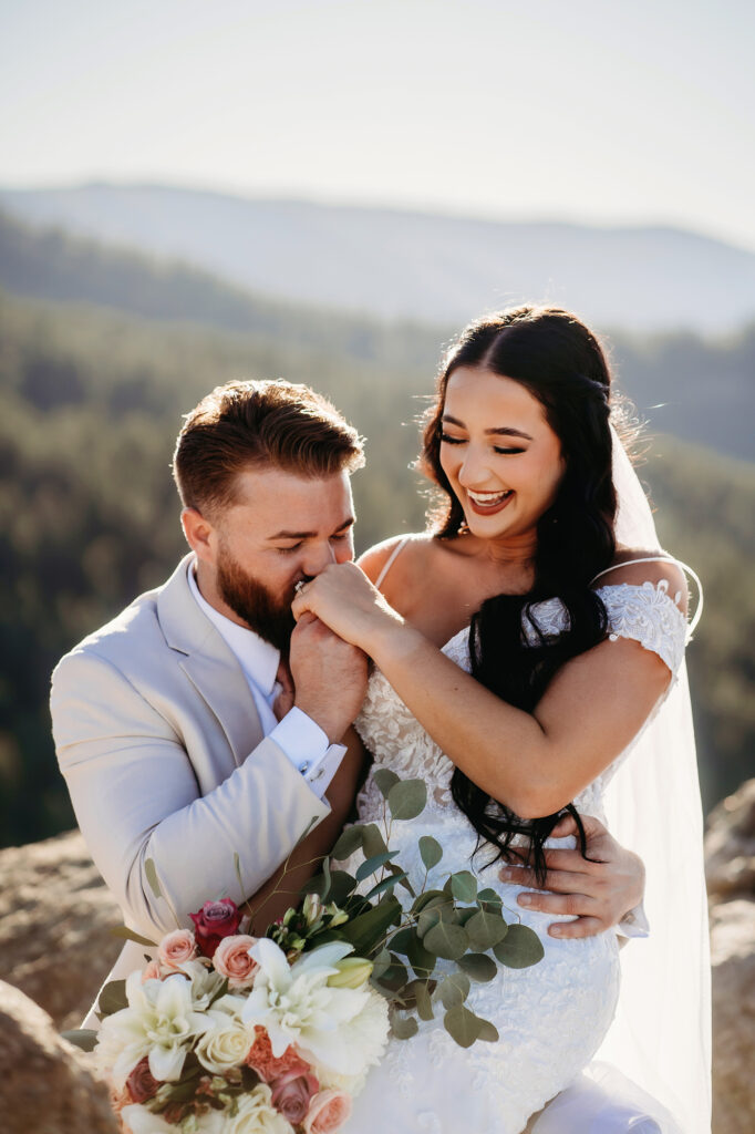 Colorado elopement photographer captures groom kissing bride's hand