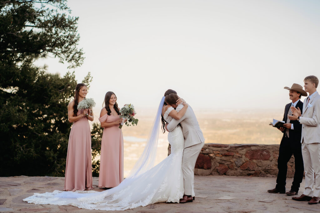 Colorado elopement photographer captures groom hugging his bride after elopement ceremony in Colorado