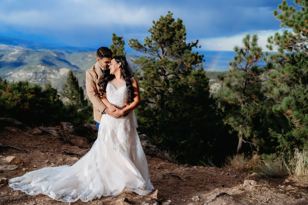 Colorado elopement photographer captures groom hugging bride during bridal portraits after Colorado elopement ceremony