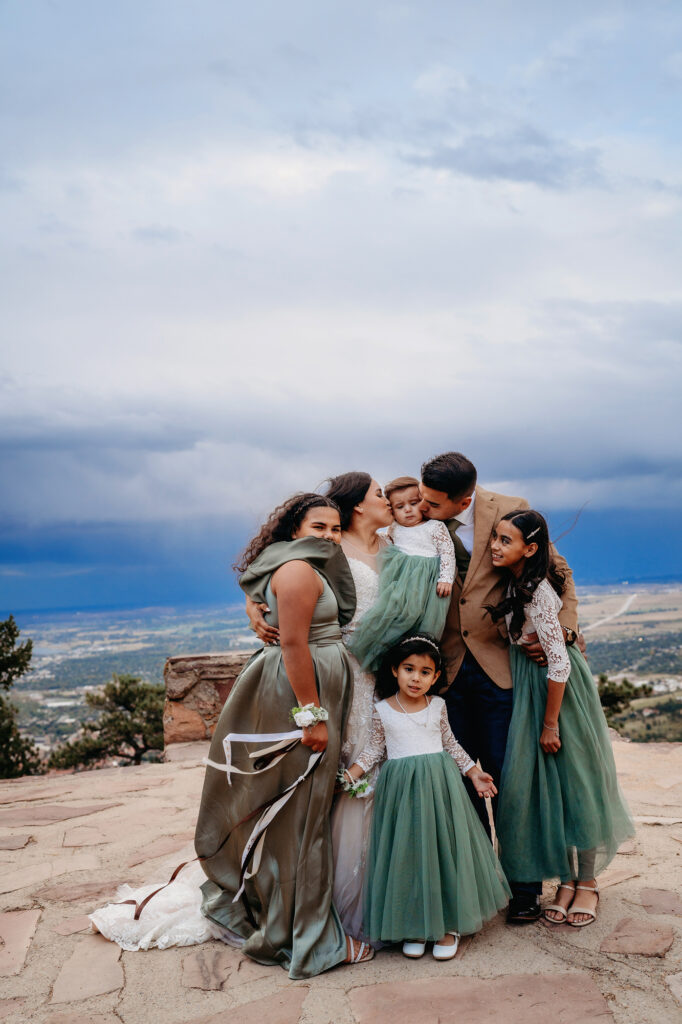 Colorado elopement photographer captures young family smiling and kissing celebrating recent Colorado elopement