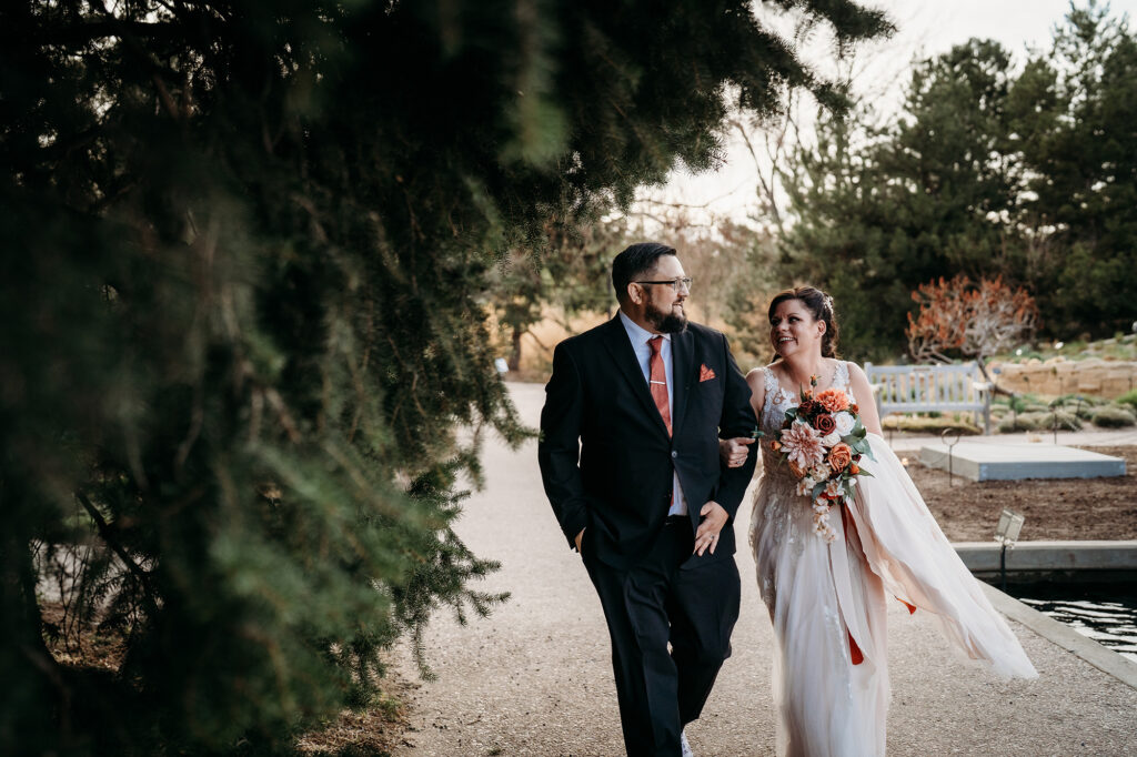 Colorado elopement photographer captures bride and groom walking with arms linked