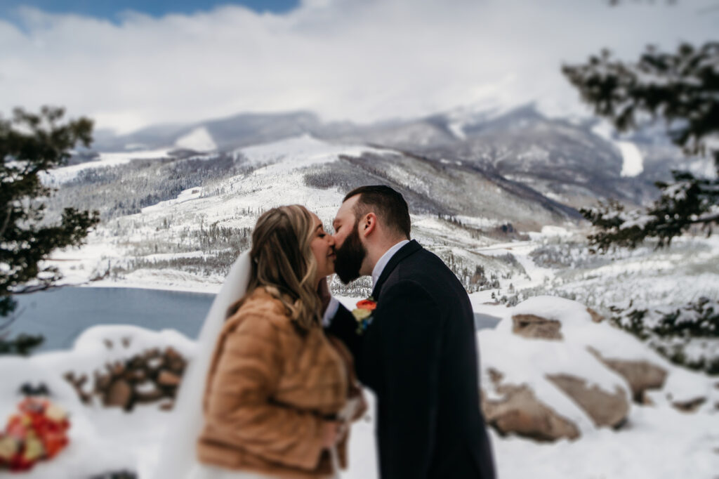 Colorado wedding photographer captures bride and groom kissing after wedding ceremony