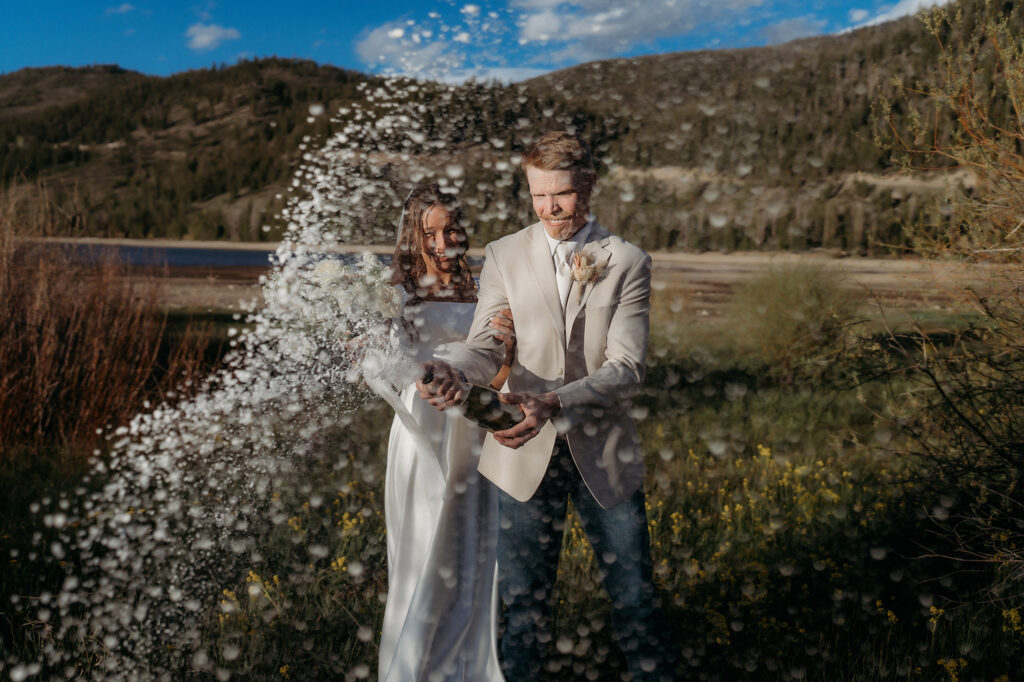 Colorado Elopement Photographer captures bride and groom popping champagne after adventurous wedding