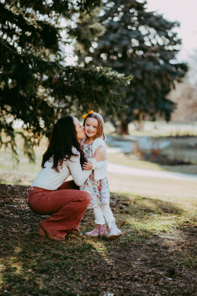 Denver family photographer captures mother kissing child during Denver family photography session
