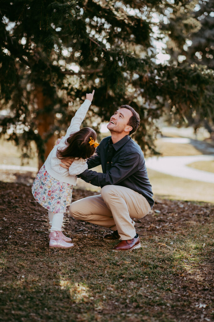 Denver family photographer captures father playing with daughter during outdoor Denver family photography