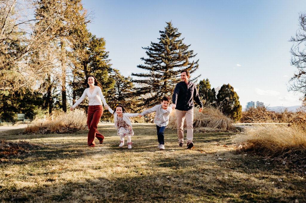 Denver family photographer captures family walking together through field