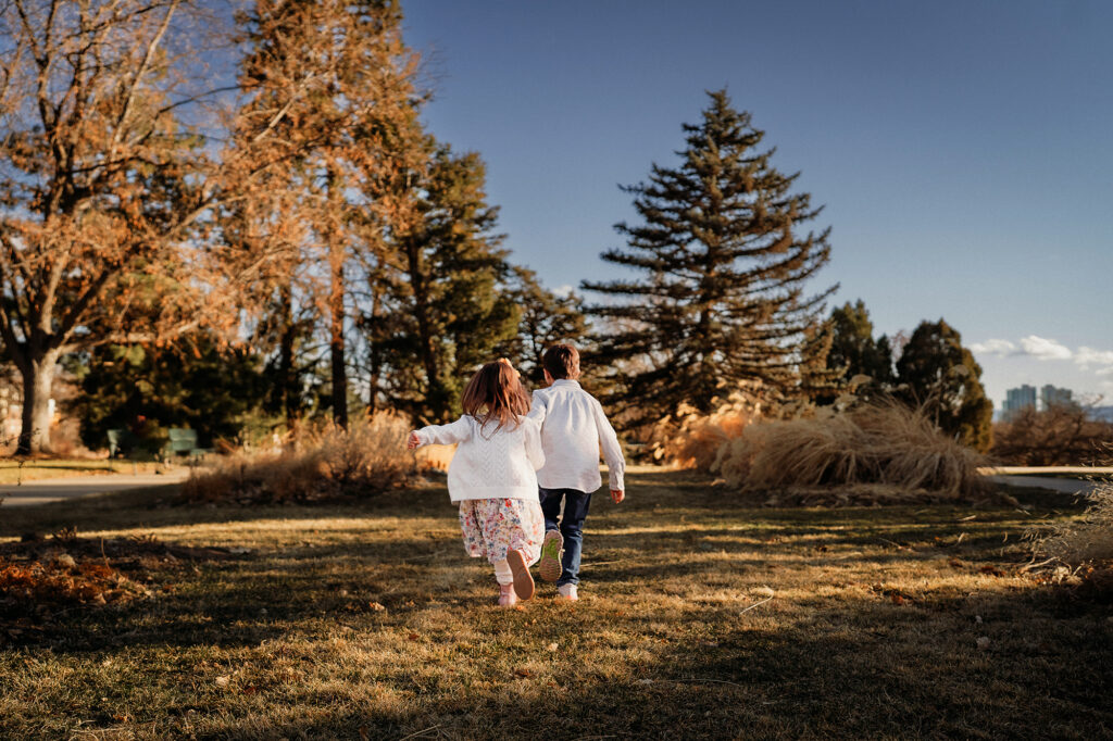 Denver Family Photographer captures children running in field