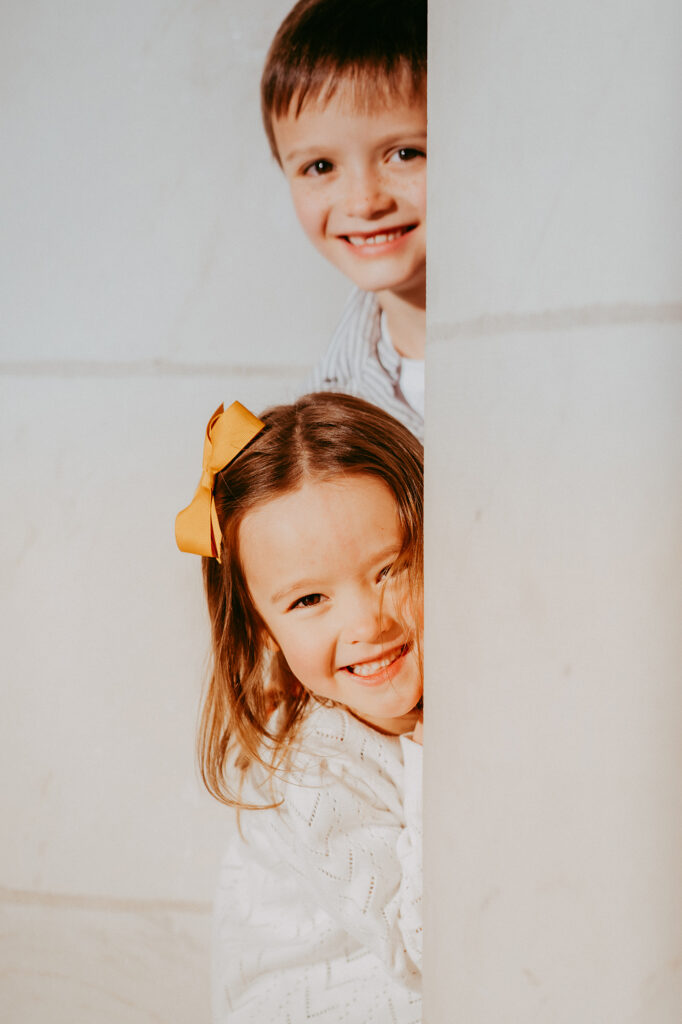 Denver Family Photographer captures brother and sister playing together during outdoor family session