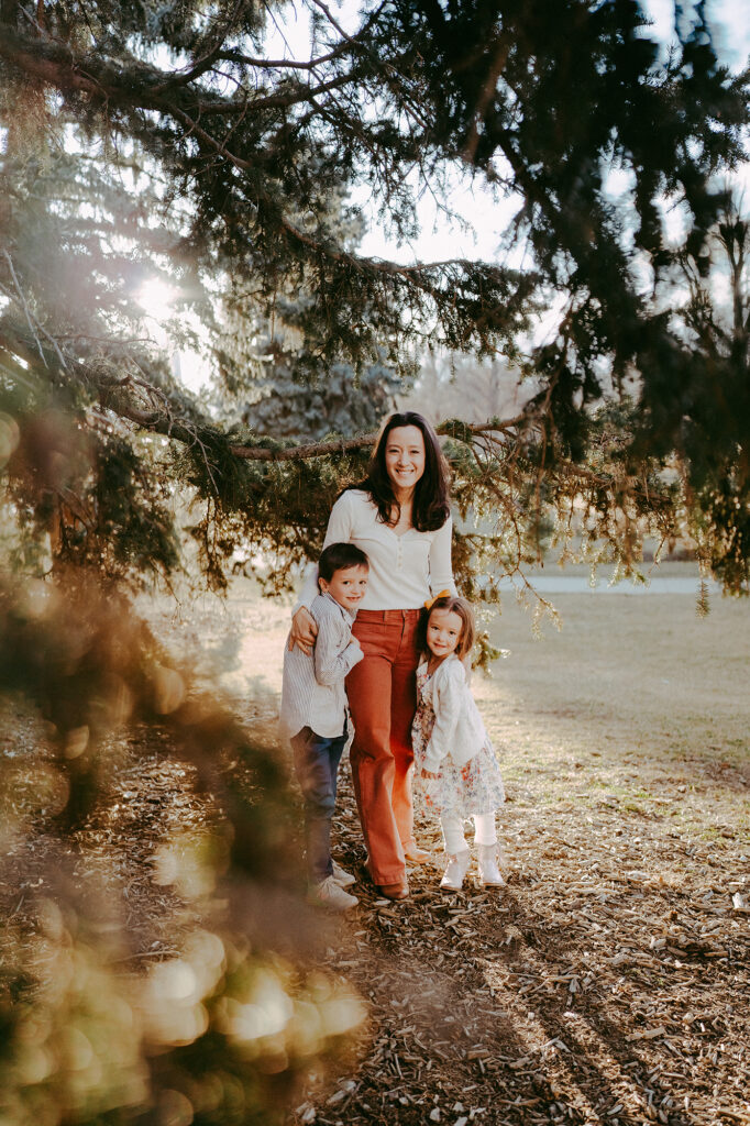 Denver Family Photographer captures mom standing with kids during outdoor family photos