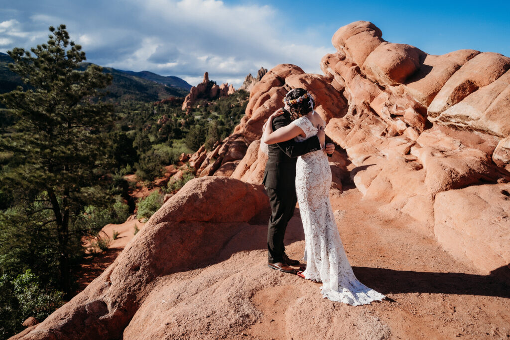 Denver Wedding Photographer captures bride and groom hugging after Chic Garden of the Gods elopement