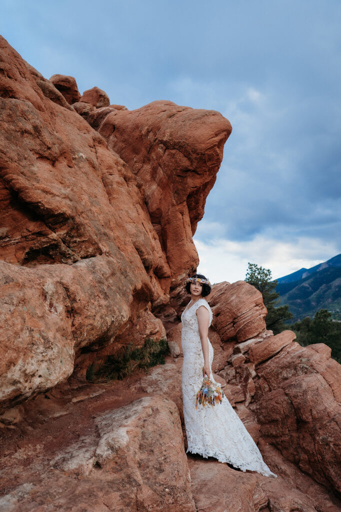 Denver Wedding Photographer captures bride holding bouquet and wearing lace dress at chic garden of the gods elopement