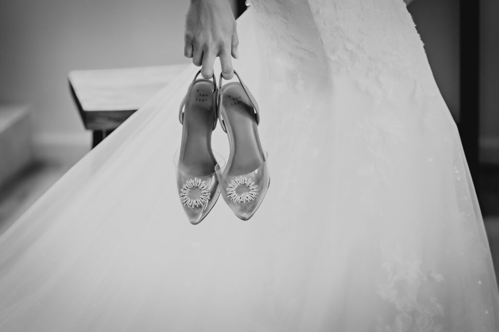 Colorado Elopement Photographer captures bride holding wedding shoes