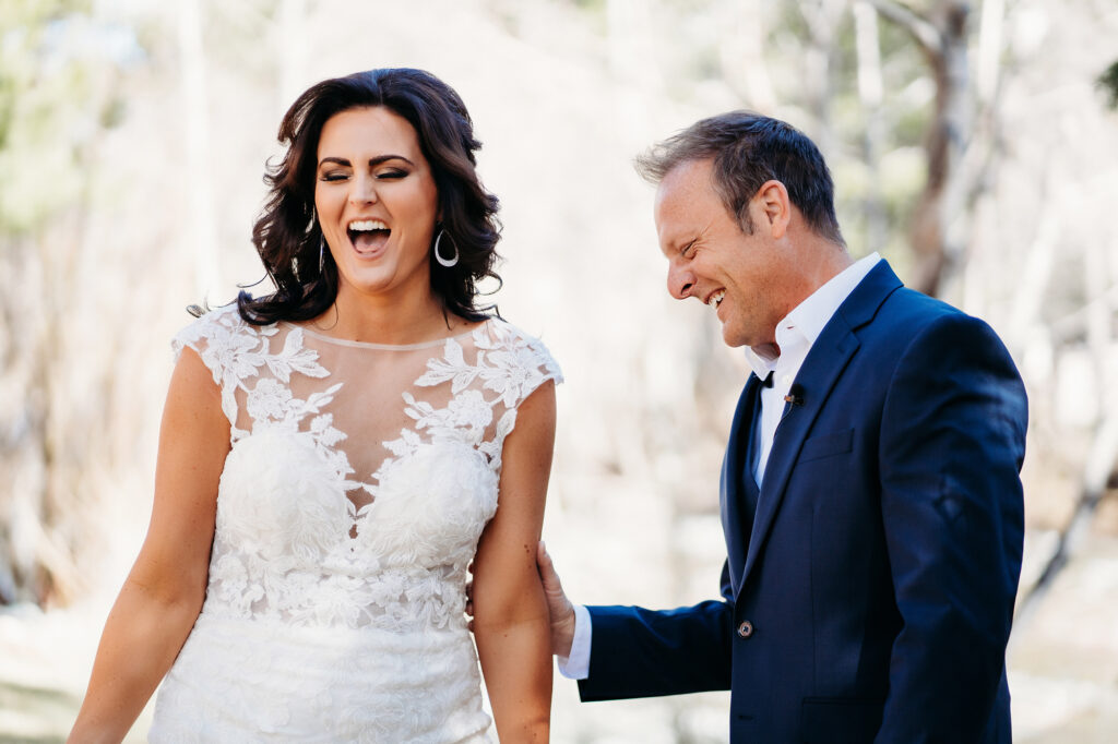 Colorado Elopement Photographer captures groom smiling at bride in wedding gown