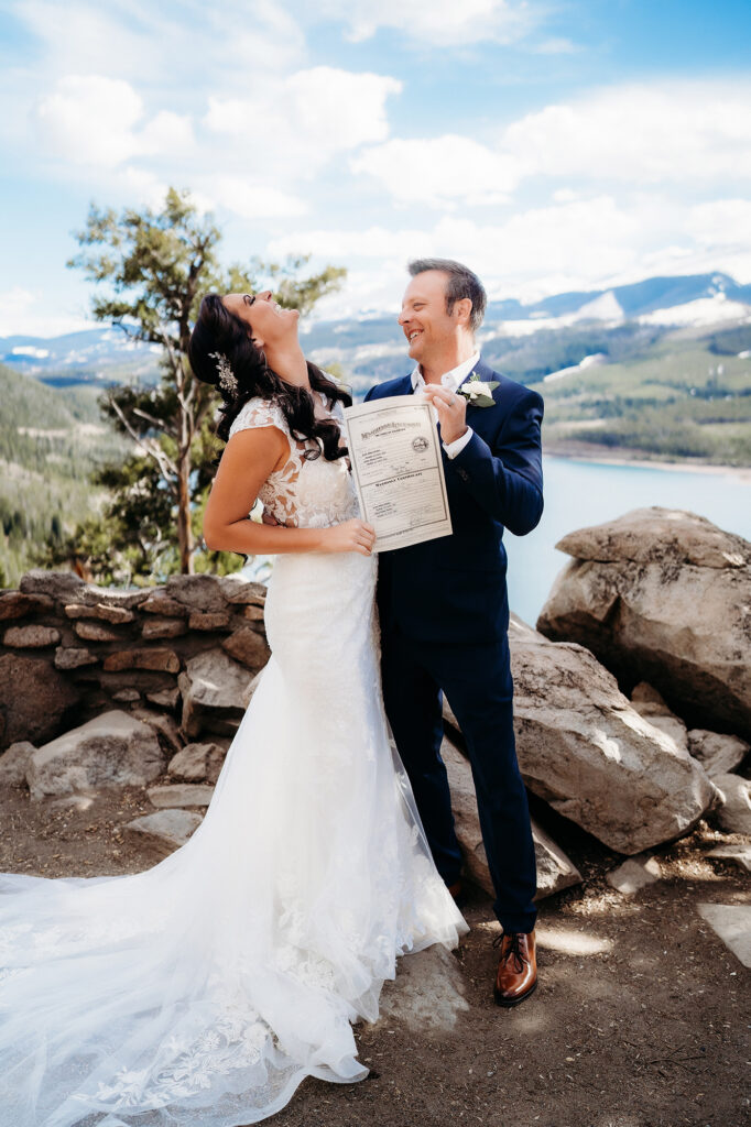 Colorado Elopement Photographer captures bride and groom holding marriage license 