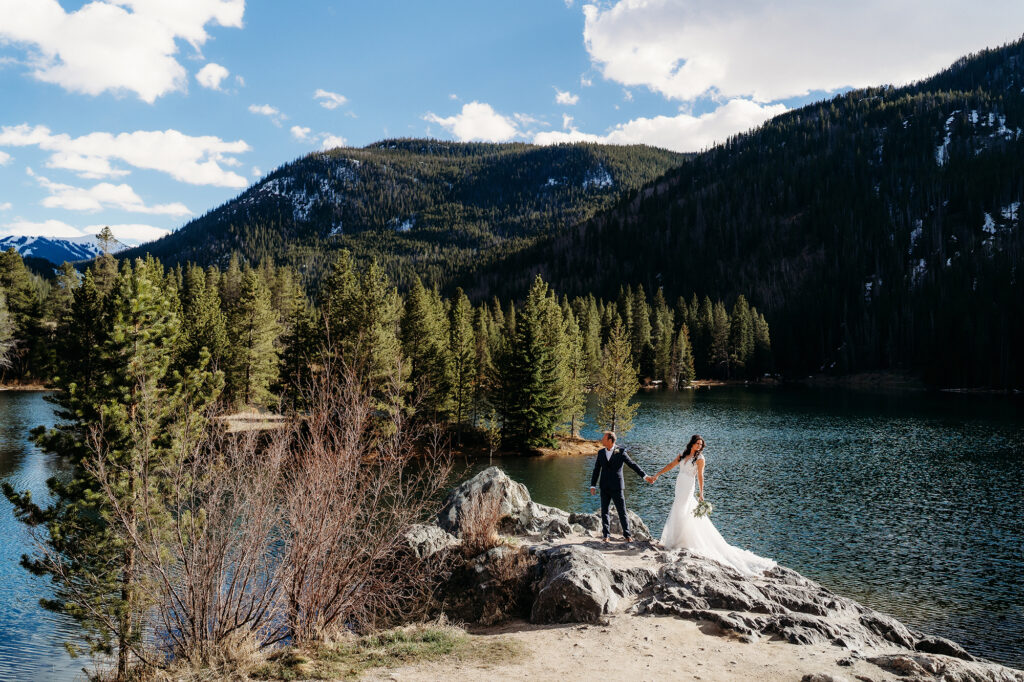 Colorado Elopement Photographer captures bride and groom walking on boulder