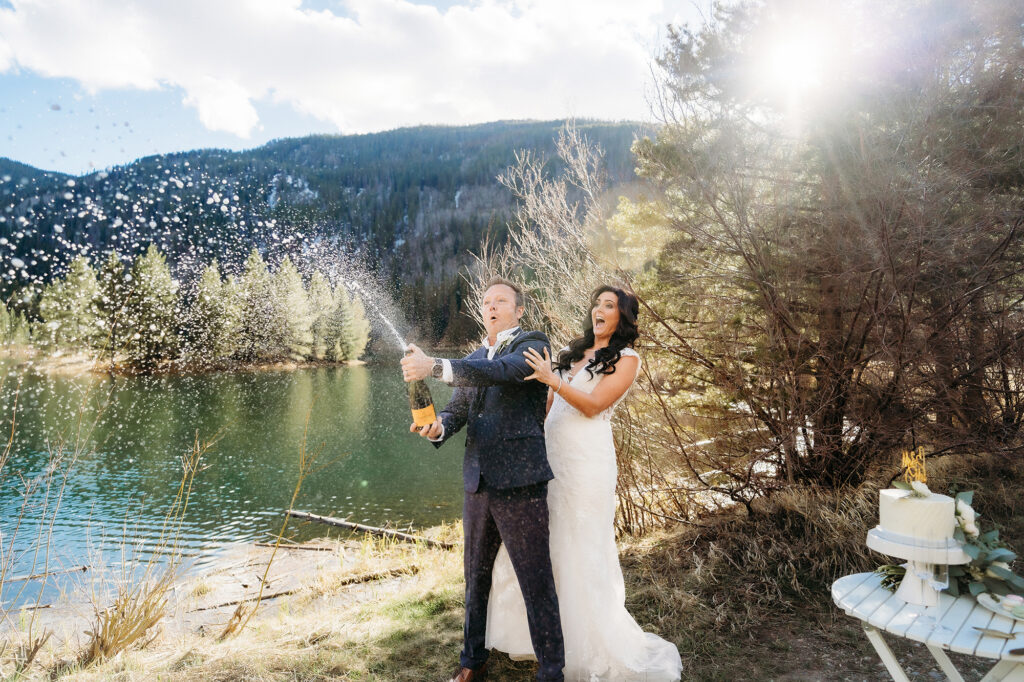 Colorado Elopement Photographer captures groom popping champagne 