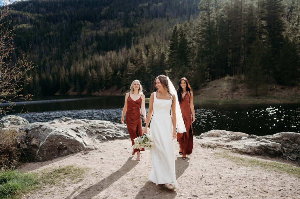 Colorado Elopement Photographer captures bride walking with bridesmaids