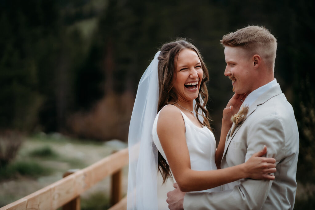 Colorado Elopement Photographer captures bride laughing with groom during outdoor bridals