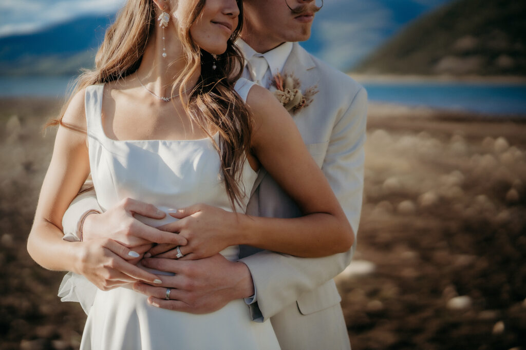 Colorado Elopement Photographer captures bride and groom holding hands while hugging