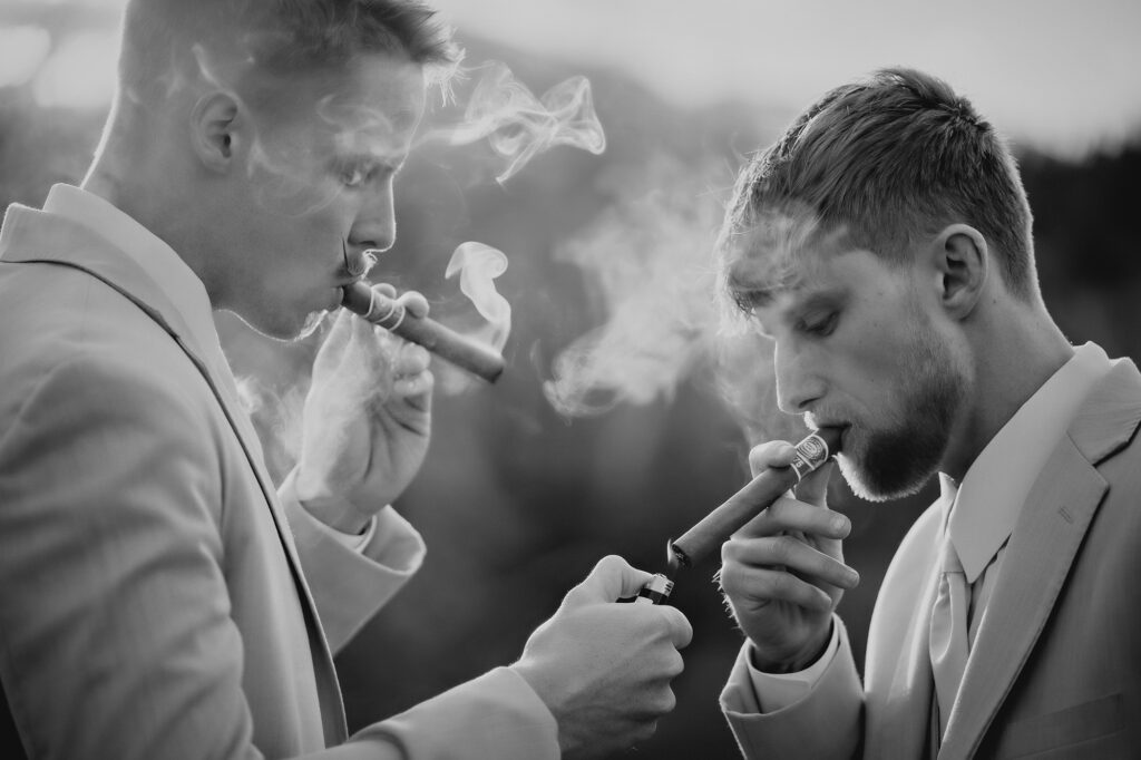 Colorado Elopement Photographer captures groom and groomsmen enjoying cigars