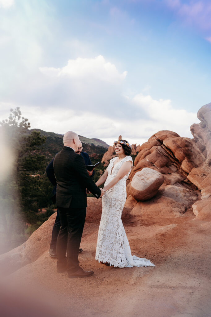 Denver Wedding Photographer captures bride and groom holding hands and celebrating