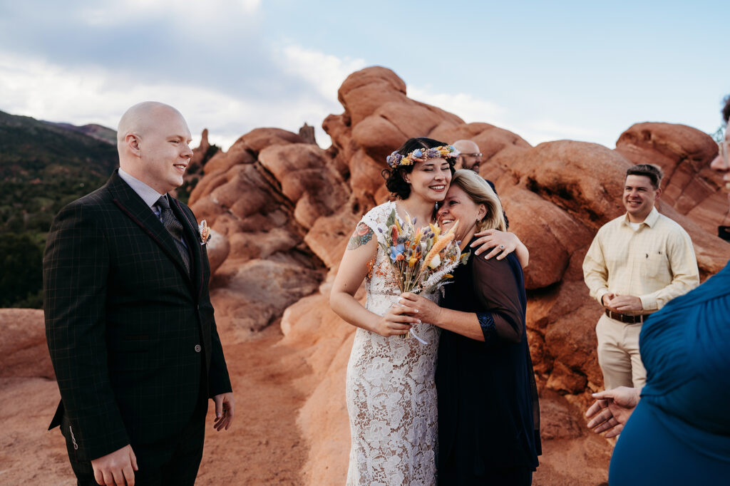 Denver Elopement Photographer captures bride hugging family