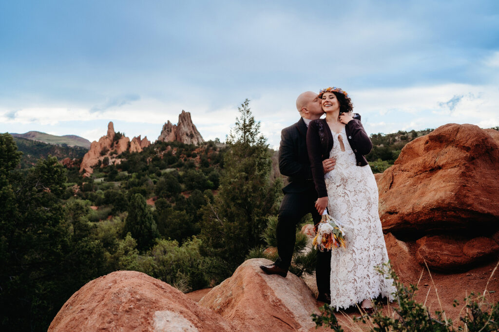 Denver Wedding Photographer captures bride and groom standing together hugging during bridal portraits