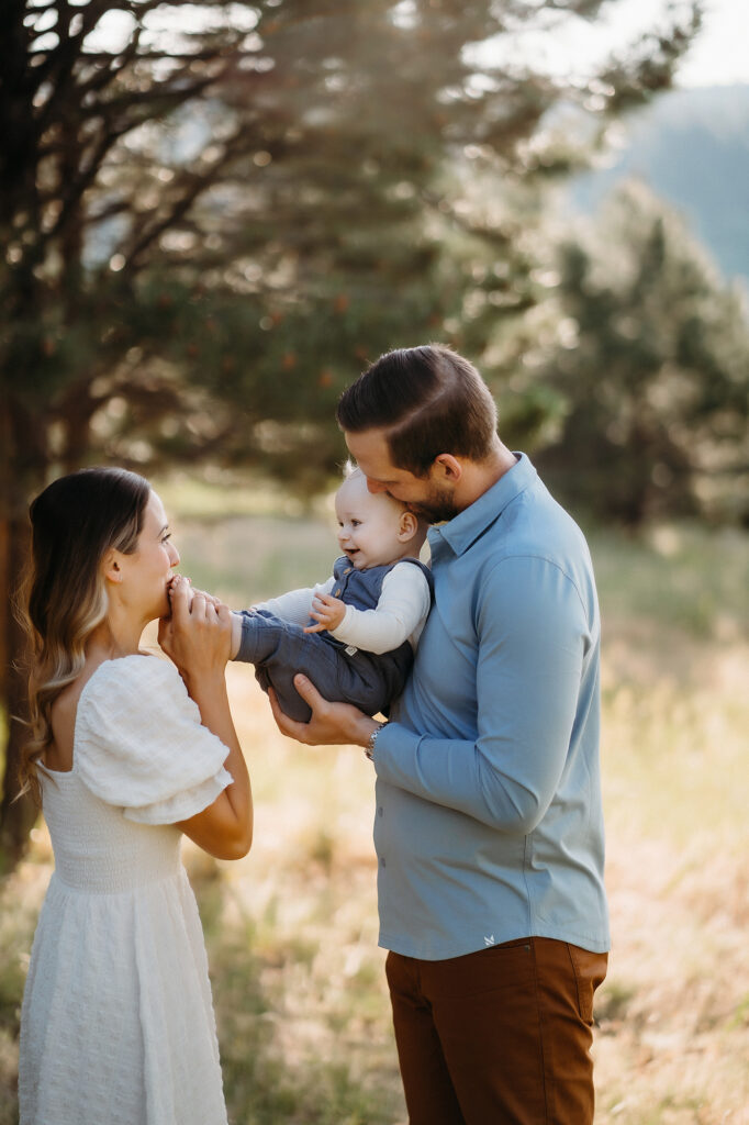 Denver Family Photographer captures father holding baby while mom kisses his feet