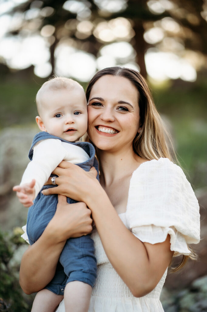 Denver Family Photographers capture mother holding baby and smiling