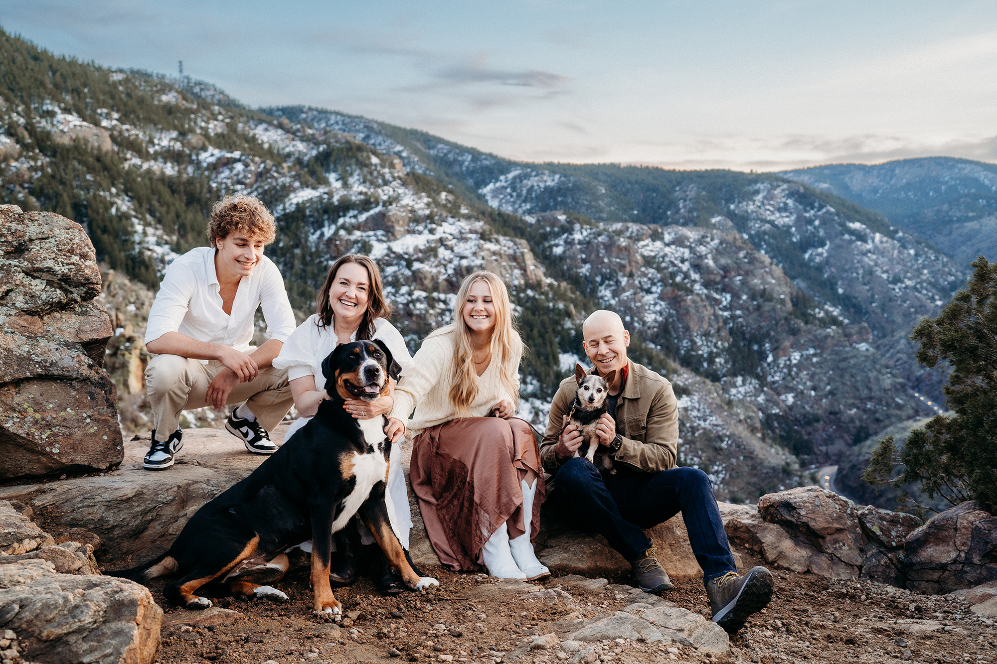 Denver Family Photographer captures family sitting on mountain during outdoor photo session with dog