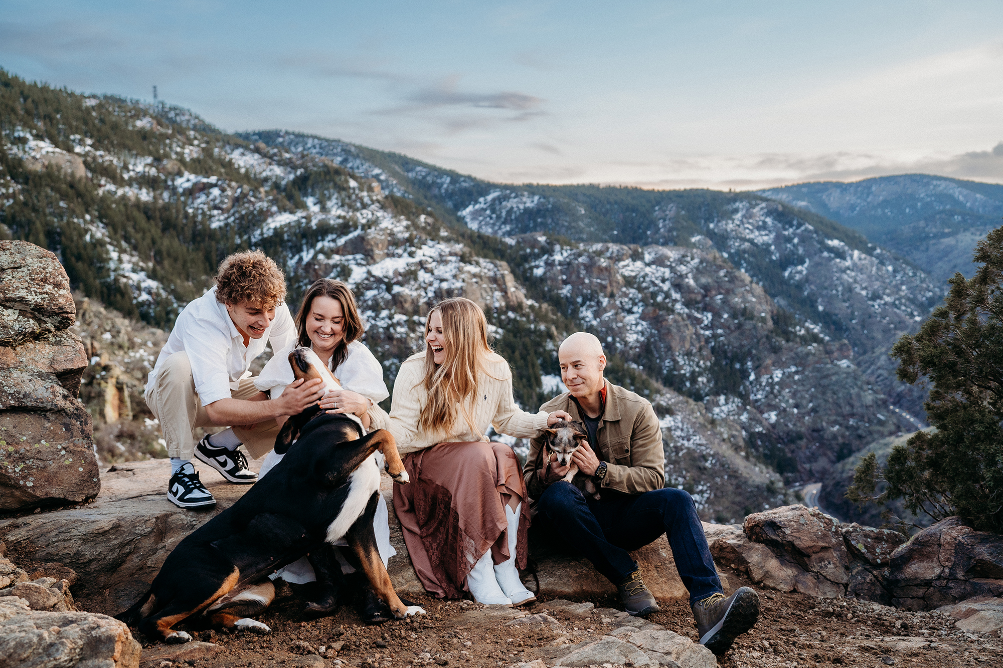 Denver Family Photographers capture family sitting on boulder during outdoor family photos