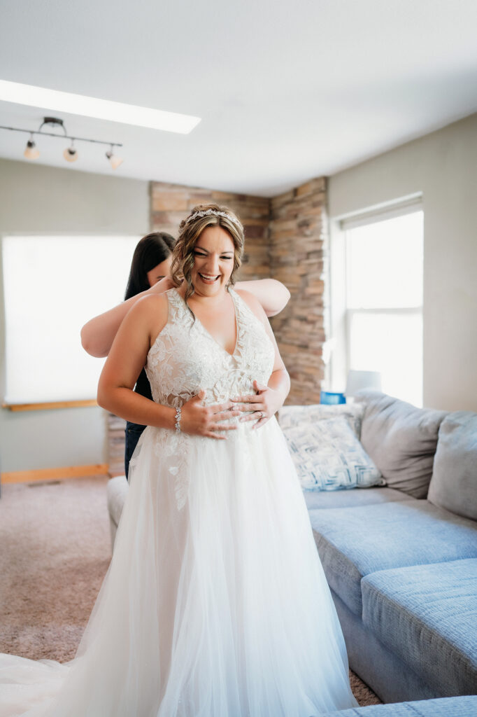 Colorado Elopement Photographer captures bride getting into wedding dress