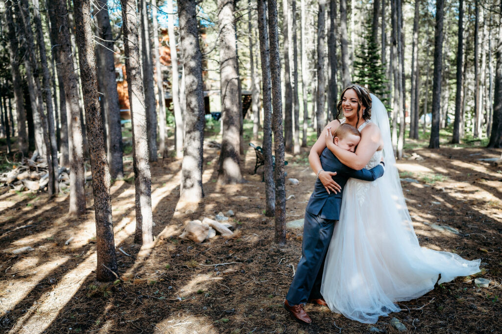 Colorado Elopement Photographer captures bride hugging son during first look