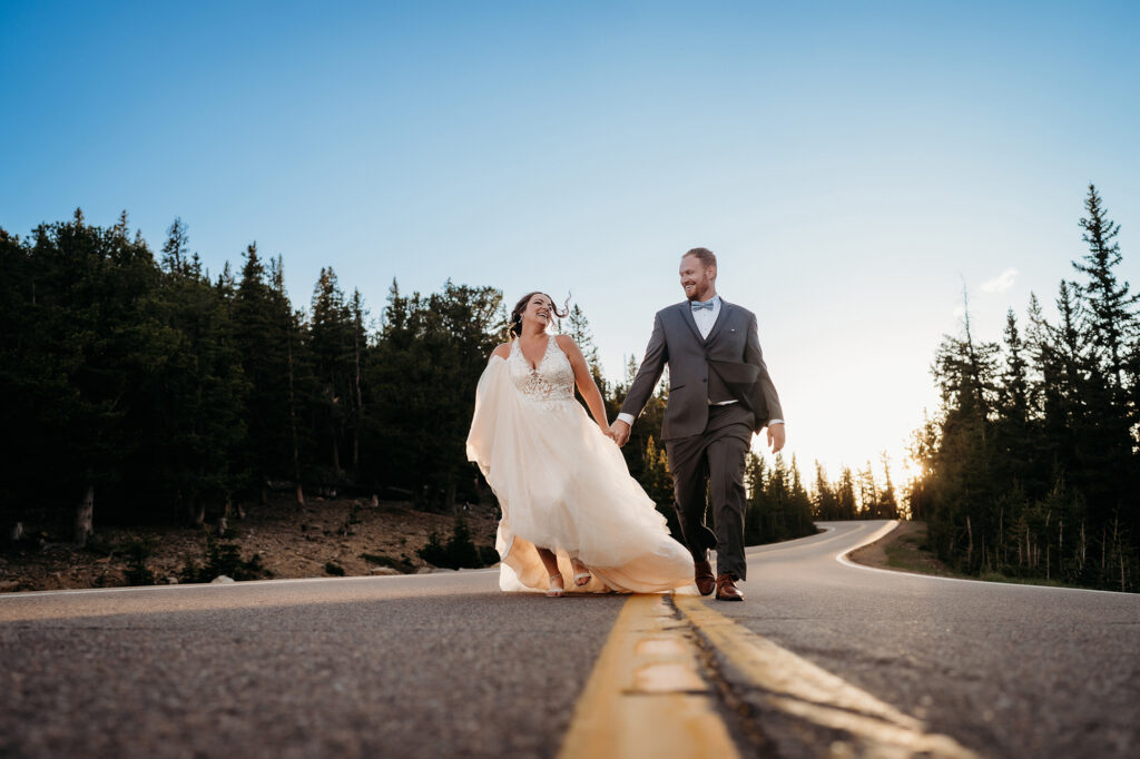 Colorado Elopement Photographer captures couple running on street together 