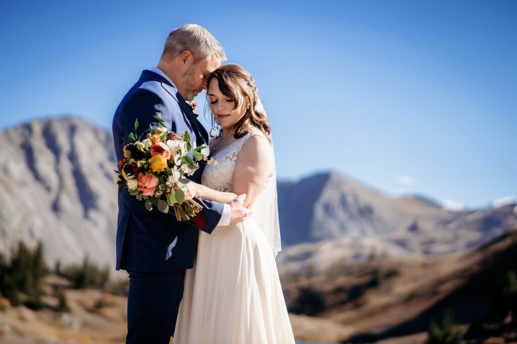 Colorado Elopement Photographer captures groom hugging bride during outdoor bridals