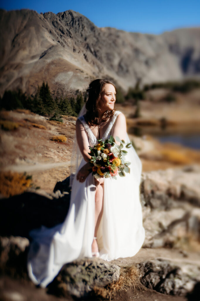 Colorado Elopement Photographer captures bride wearing wedding dress and holding bouquet