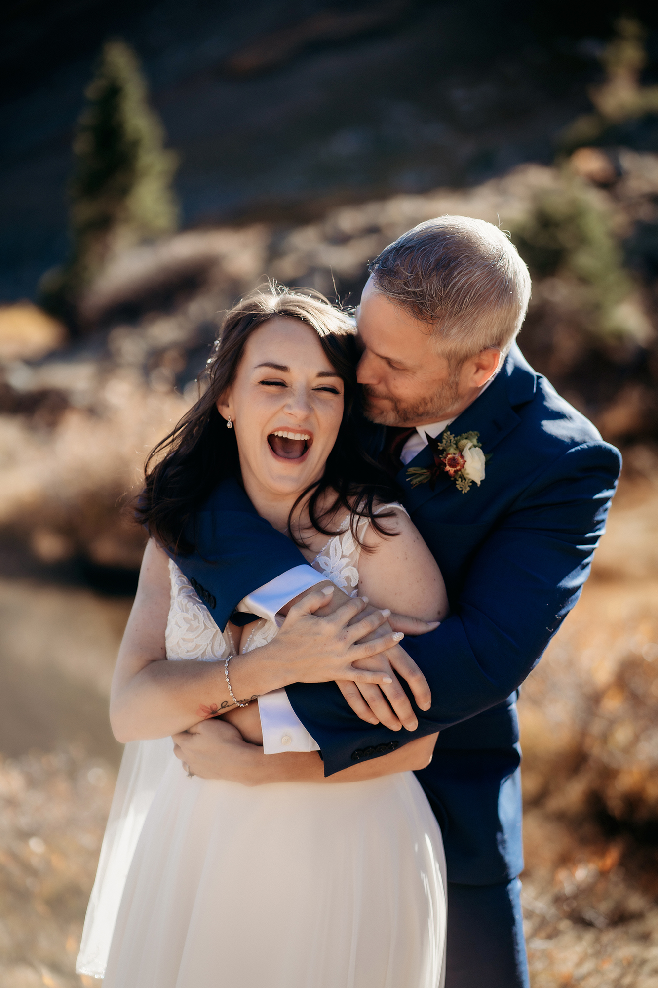 Colorado Elopement Photographer captures groom making bride laugh during outdoor bridal portraits after Colorado elopement