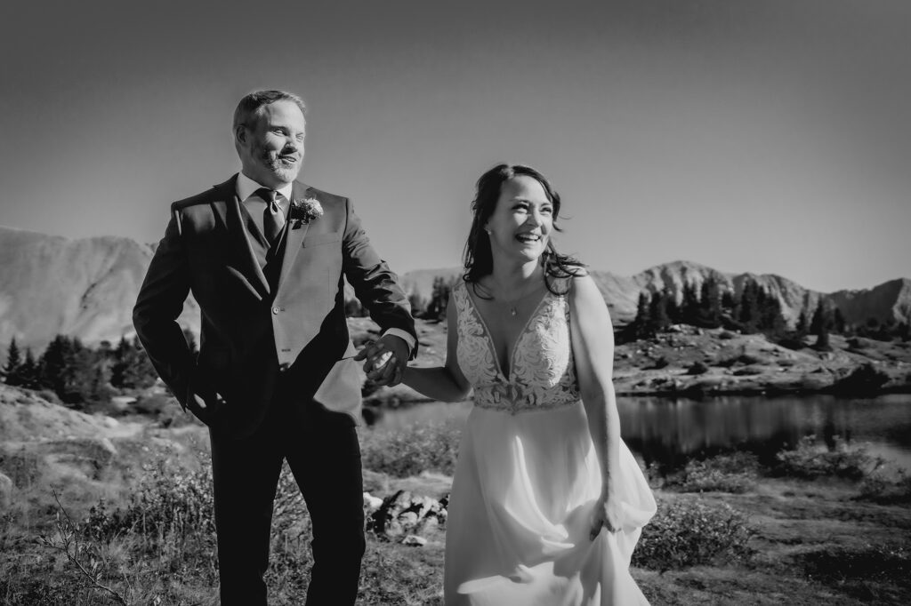 Colorado Elopement Photographer captures bride and groom running in field together