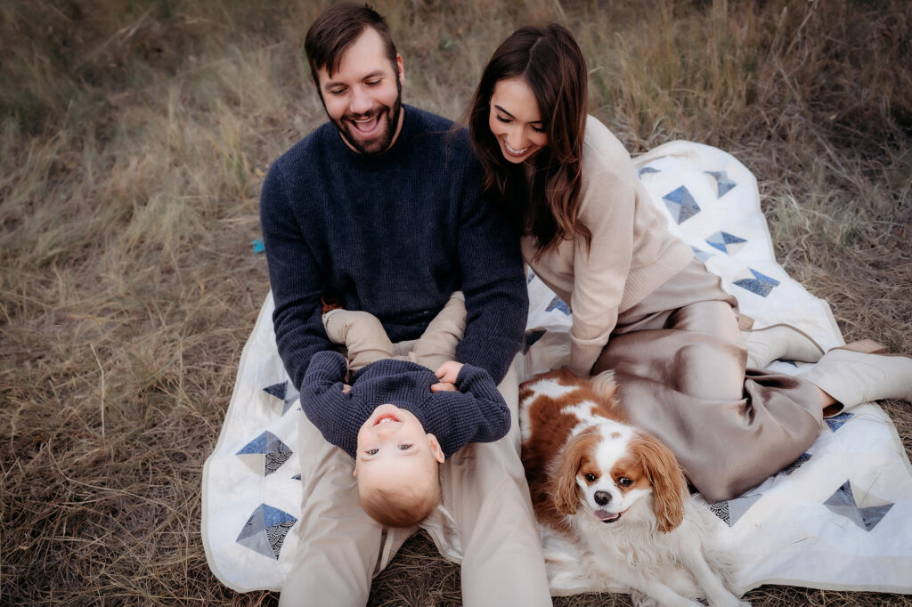 Denver Family Photographer captures mother and father after picnic playing with their child