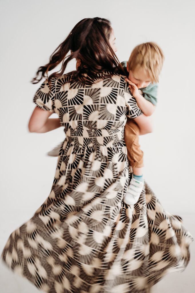 Denver Family Photographer captures mother swinging baby around while dancing