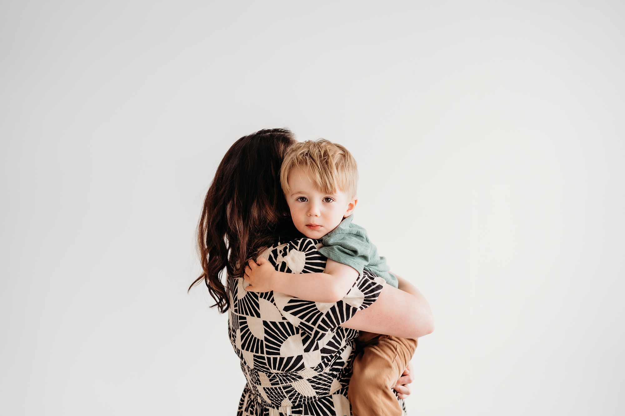 Denver Family Photographer captures son hanging on to mom during denver photo session