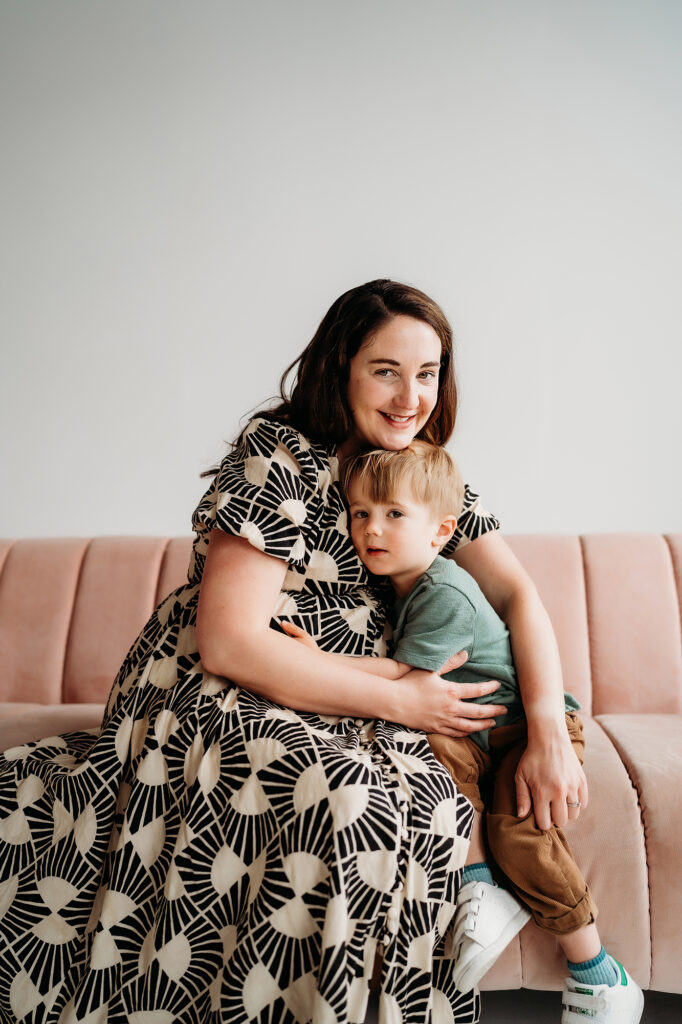 Denver Family Photographer captures mother and son sitting on couch hugging