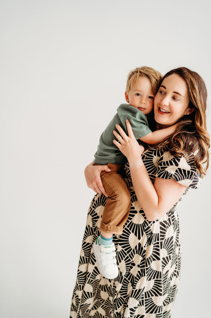 Denver Family Photographer captures mother holding baby and hugging him