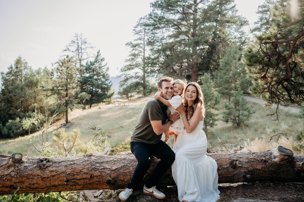 Denver Family Photographer captures family sitting on a log during outdoor family photos